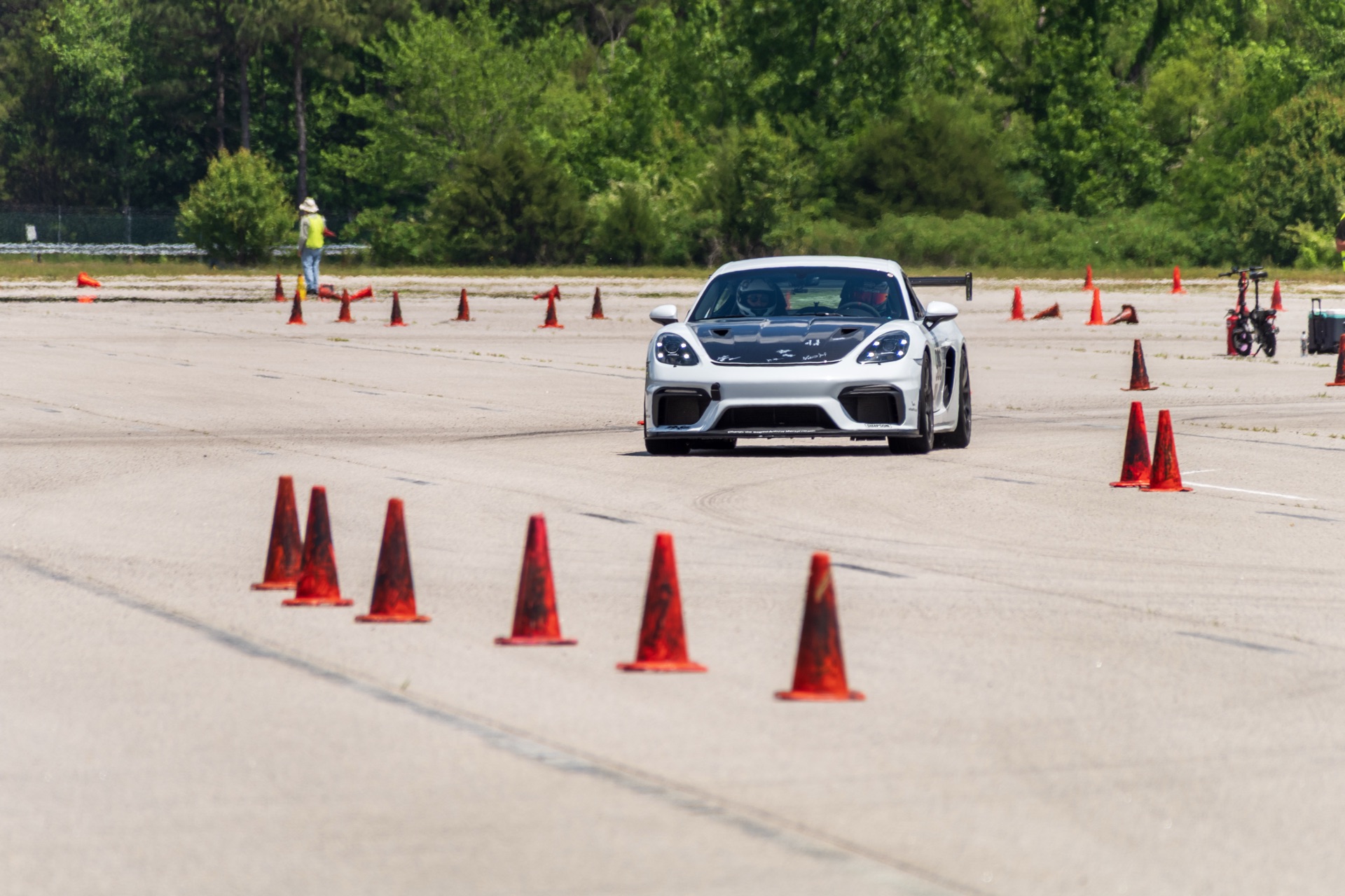 Cayman GT4 number 988 front view threading cone slalom mid-run