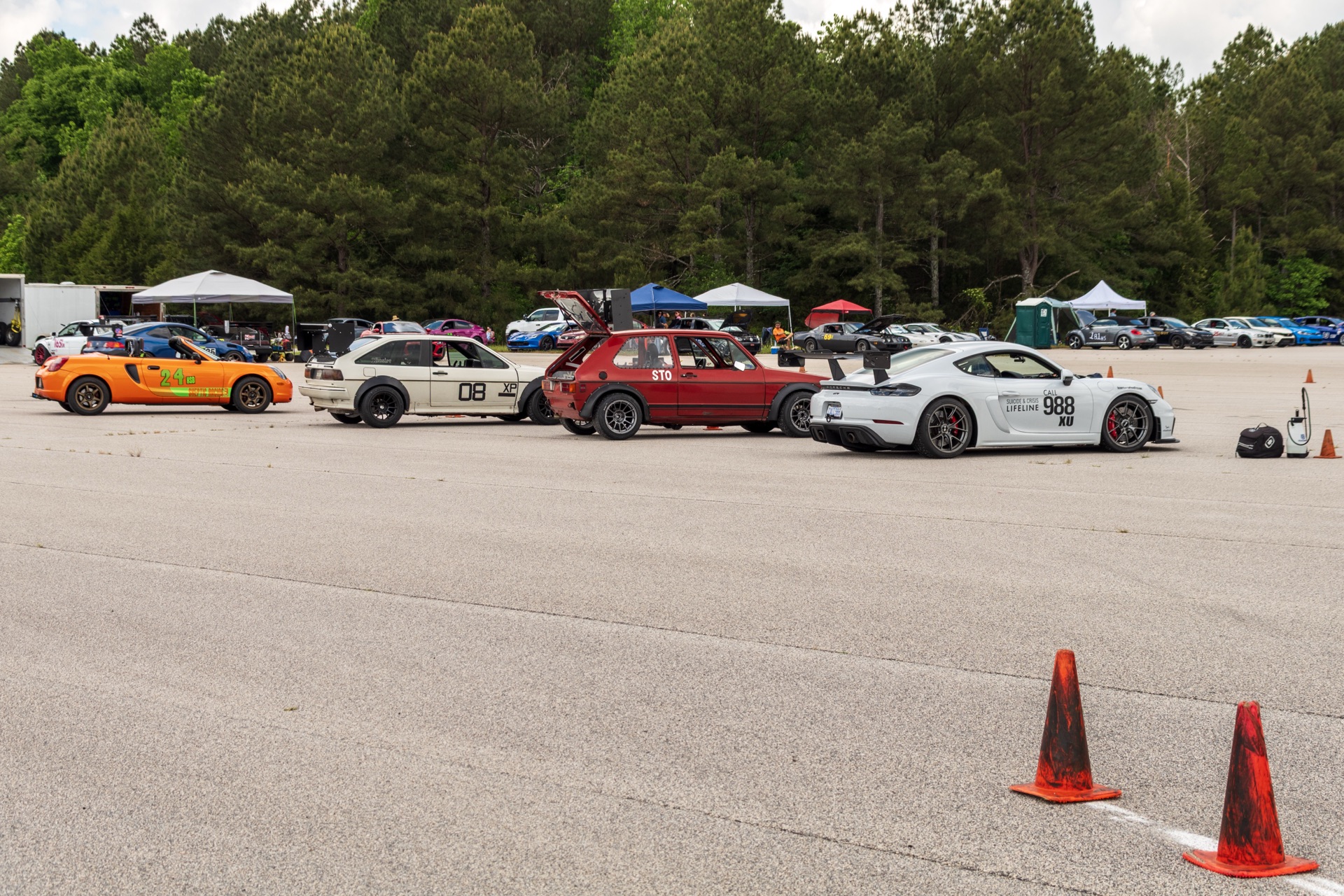 CCR SCCA autocross paddock lineup with orange BMW white Civic red VW Caddy and Team Wheelhouse Cayman