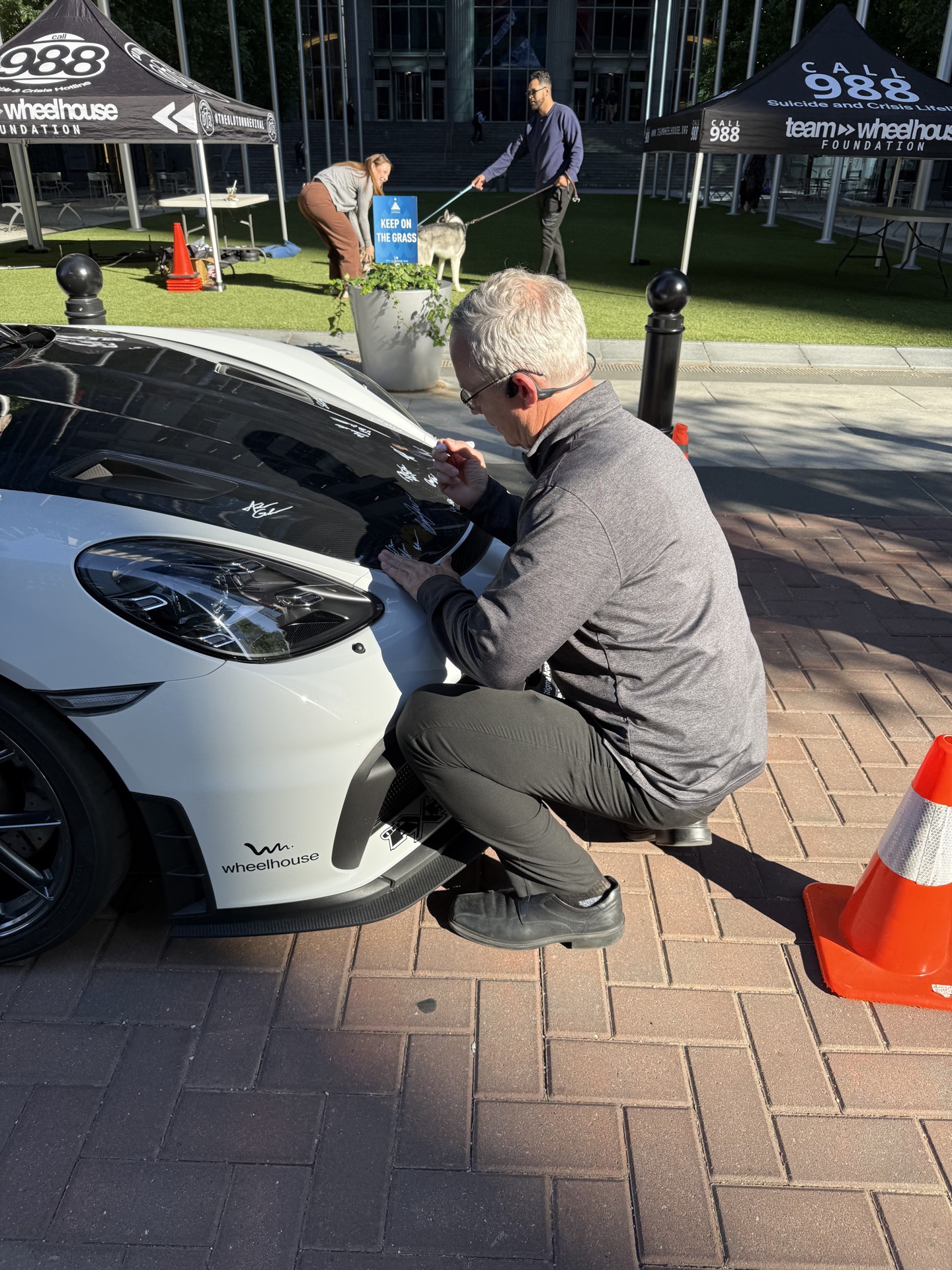 Chris Shearer setting up the Team Wheelhouse Porsche 718 Cayman GT4 on the green at Legacy Union