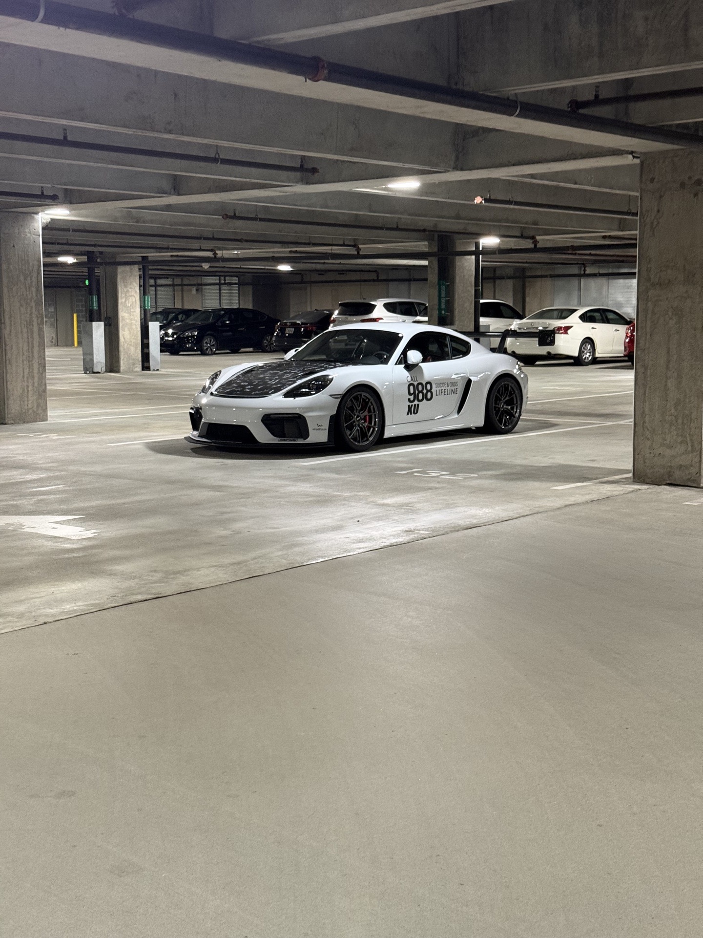 Team Wheelhouse Porsche 718 Cayman GT4 988 Suicide and Crisis Lifeline livery staged in the Legacy Union parking garage