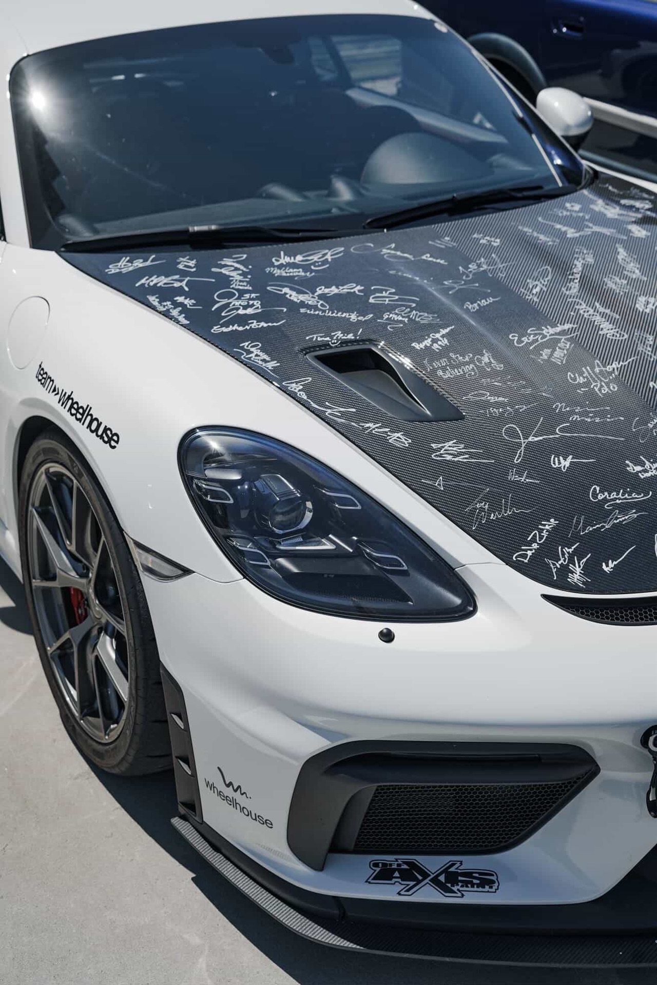 Team Wheelhouse Porsche 718 Cayman GT4 with signatures across the carbon-fiber hood