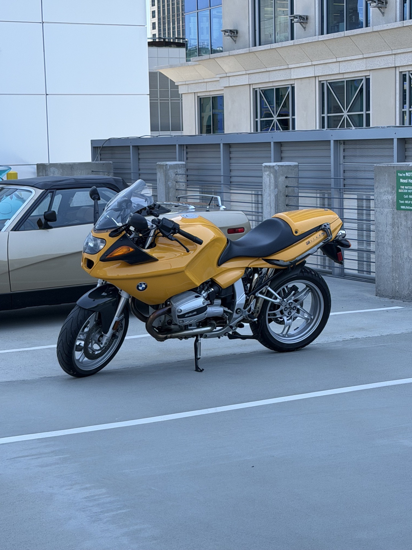 Yellow BMW R 1100 S sport motorcycle parked on the Legacy Union rooftop deck